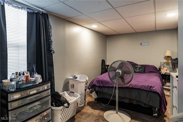 carpeted bedroom with a paneled ceiling