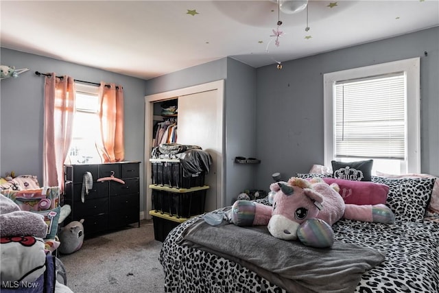 carpeted bedroom featuring a closet and ceiling fan