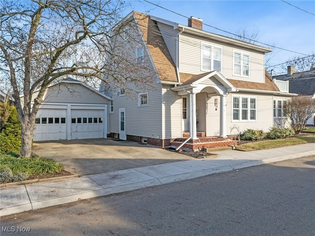 view of front of property featuring an outdoor structure and a garage