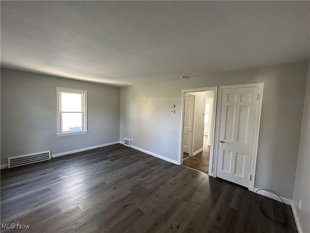 empty room featuring dark wood-type flooring