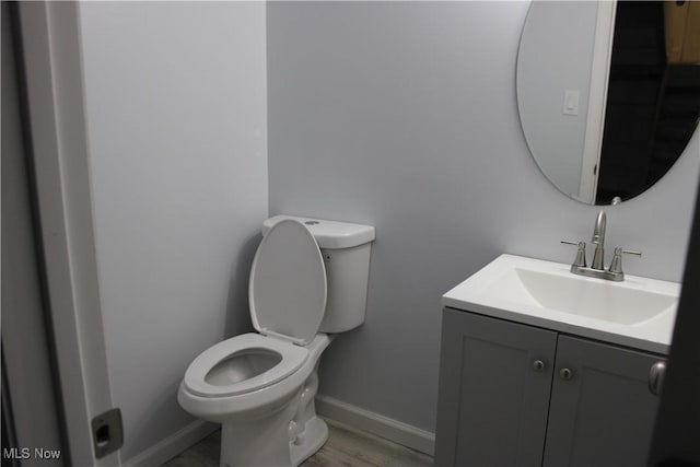 bathroom featuring vanity, toilet, and wood-type flooring