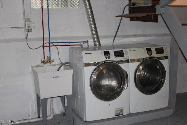 laundry room with independent washer and dryer and sink