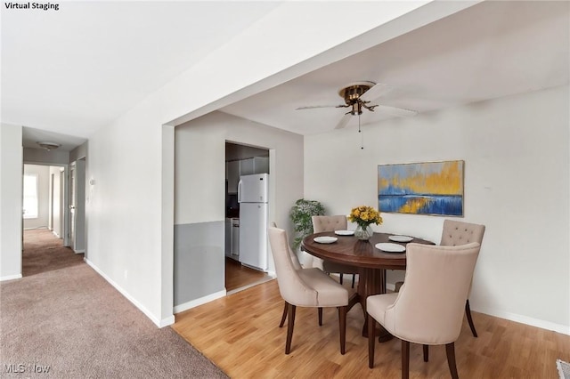 dining space featuring hardwood / wood-style flooring and ceiling fan