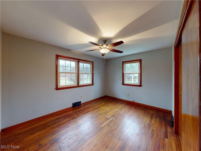 empty room with wood-type flooring and ceiling fan