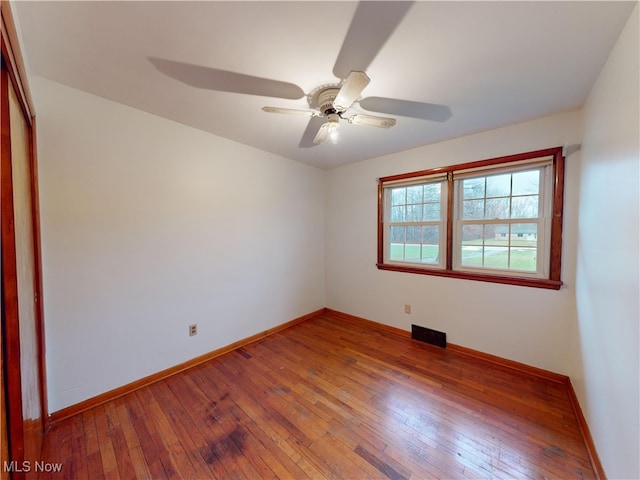 spare room featuring ceiling fan and hardwood / wood-style floors