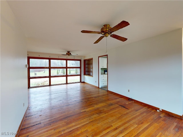 spare room featuring ceiling fan and light wood-type flooring