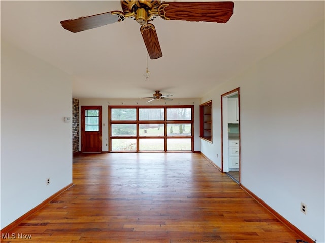 unfurnished living room featuring hardwood / wood-style flooring and ceiling fan