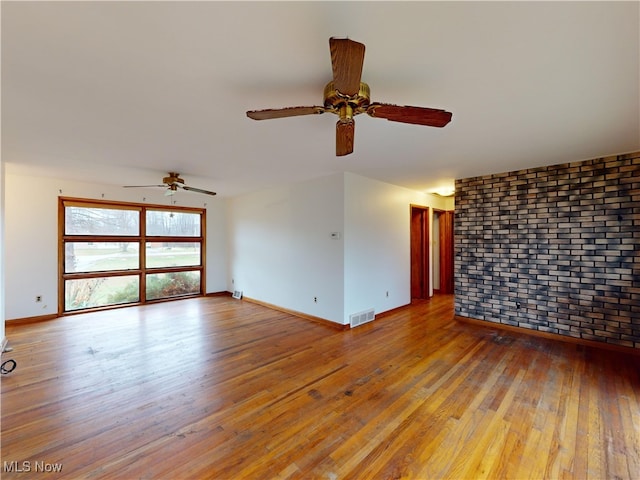 spare room featuring ceiling fan and hardwood / wood-style flooring