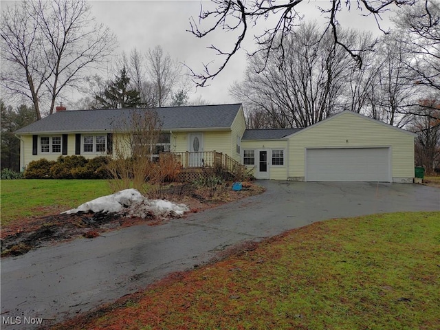 ranch-style home featuring a garage and a front yard