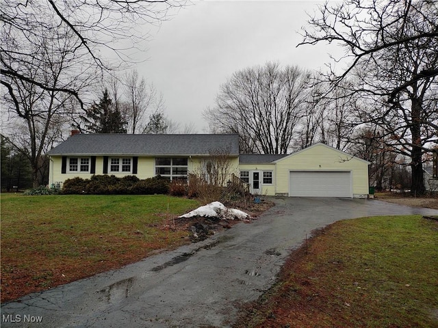 ranch-style home with a garage and a front yard