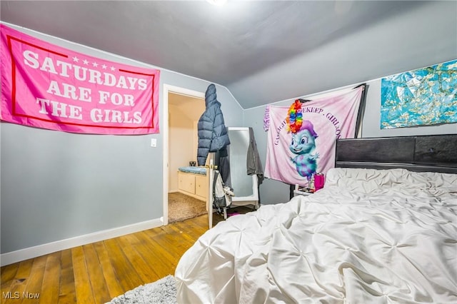 bedroom with wood-type flooring and lofted ceiling