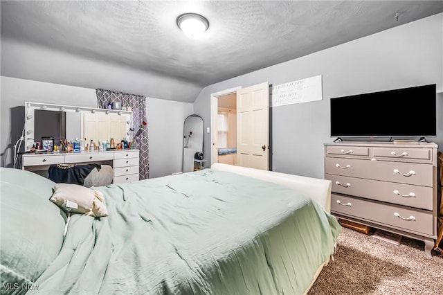 carpeted bedroom featuring a textured ceiling