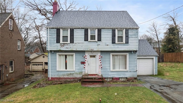 view of front of property featuring a garage and a front lawn