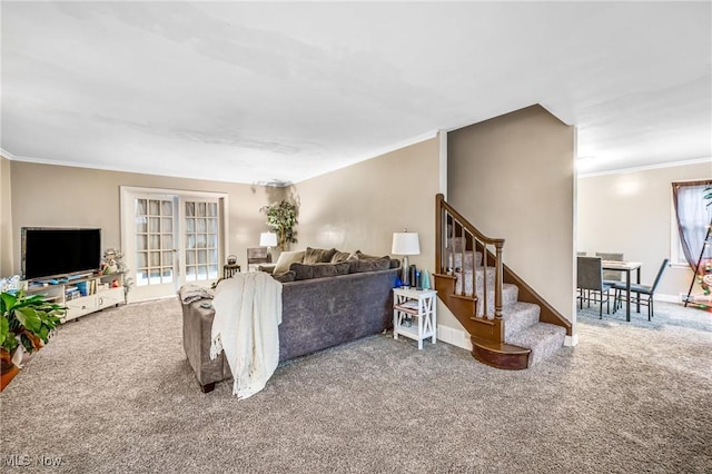 carpeted living room featuring a healthy amount of sunlight and ornamental molding