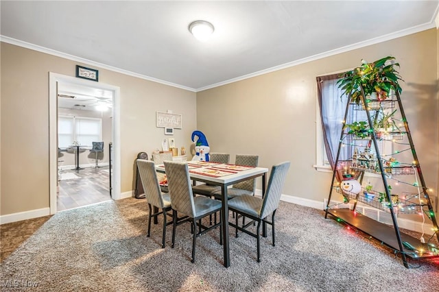 carpeted dining area featuring a wealth of natural light and ornamental molding