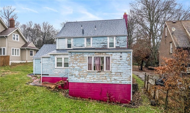 back of house featuring a yard