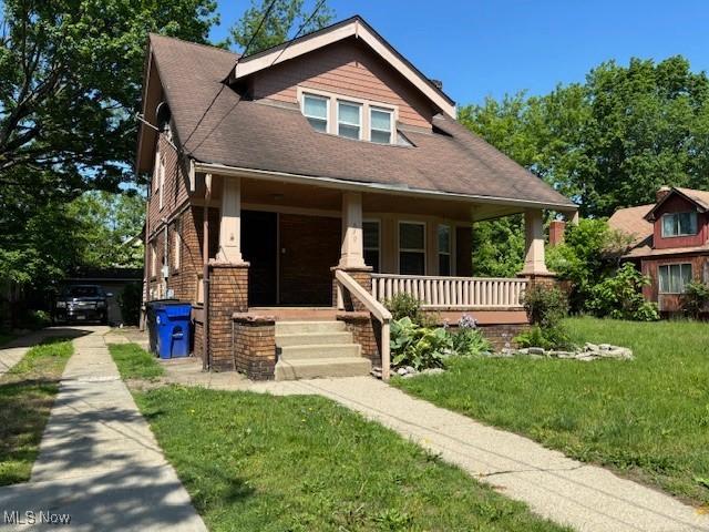 view of front of home with a front yard and a porch