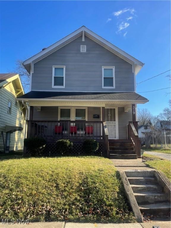 view of front of home with a porch and a front yard