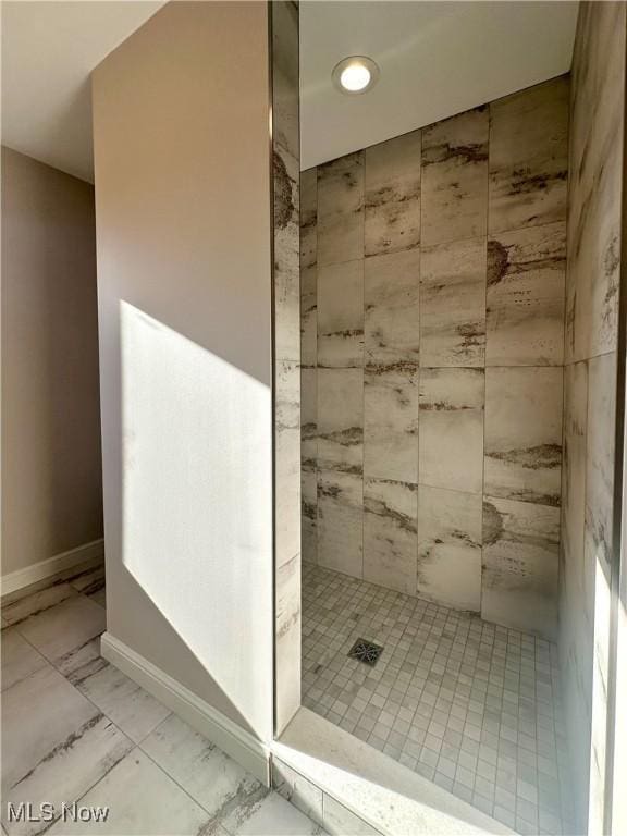 bathroom with tiled shower