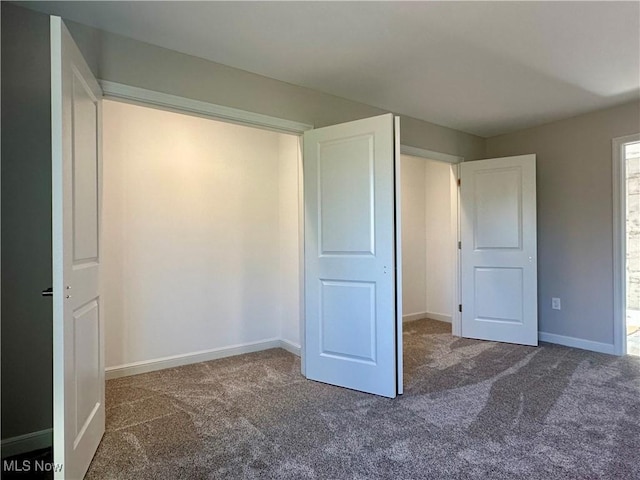 unfurnished bedroom with dark carpet