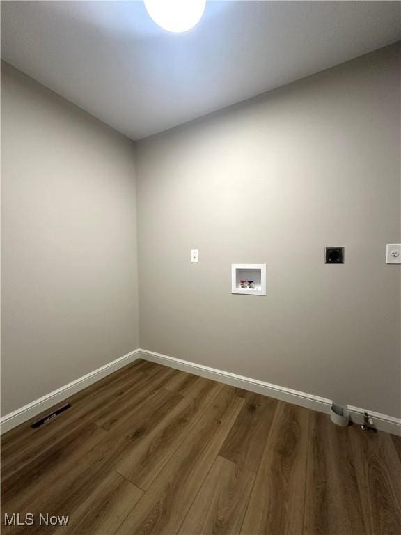 laundry room featuring electric dryer hookup, hardwood / wood-style floors, and washer hookup