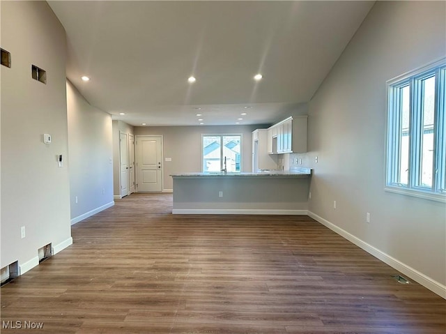 unfurnished living room featuring light hardwood / wood-style floors and sink