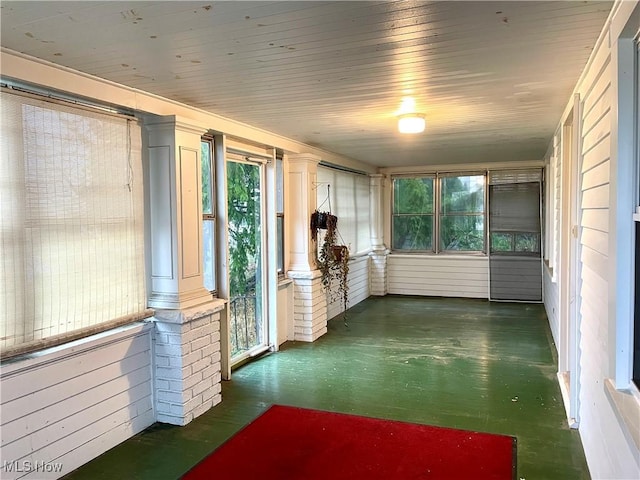 unfurnished sunroom with ornate columns and a wealth of natural light