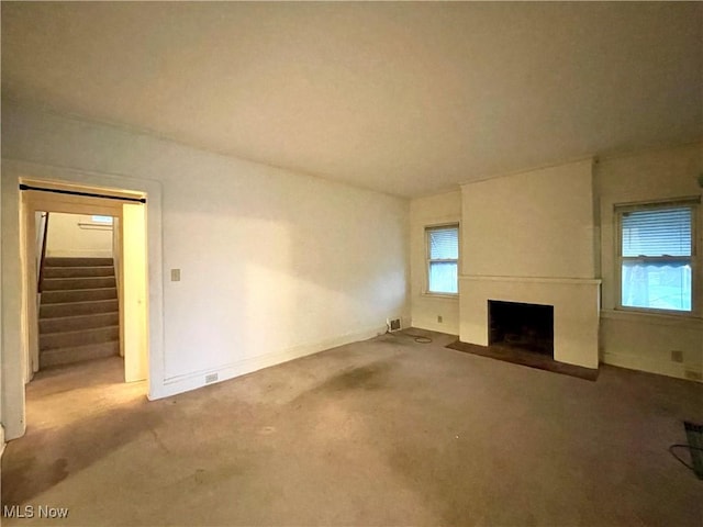 unfurnished living room featuring carpet floors