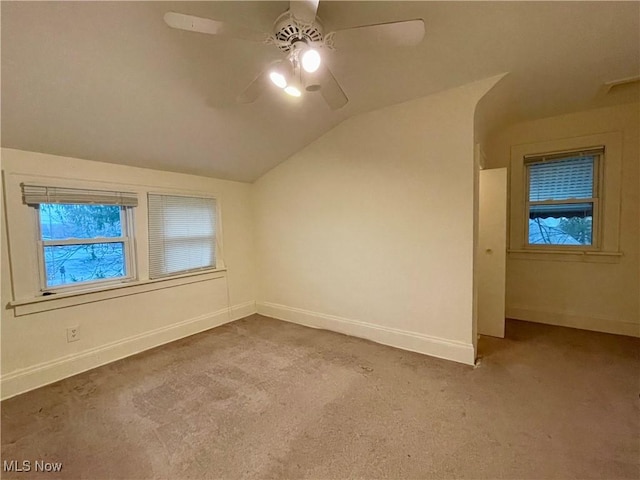 bonus room featuring ceiling fan, light carpet, and vaulted ceiling