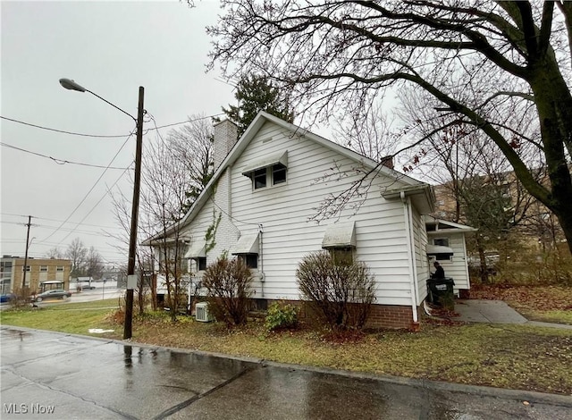 view of side of property with central AC