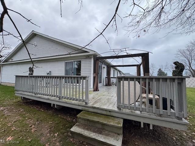 back of property with a wooden deck