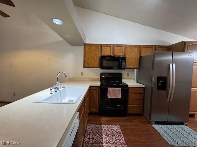 kitchen with dark hardwood / wood-style floors, sink, black appliances, and vaulted ceiling