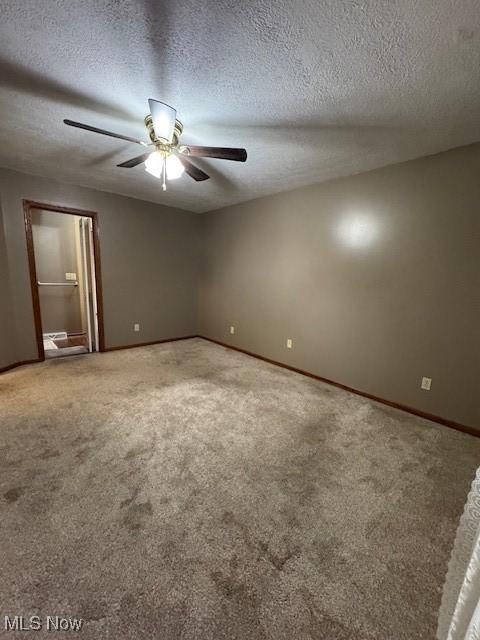 unfurnished bedroom featuring ceiling fan, carpet, and a textured ceiling