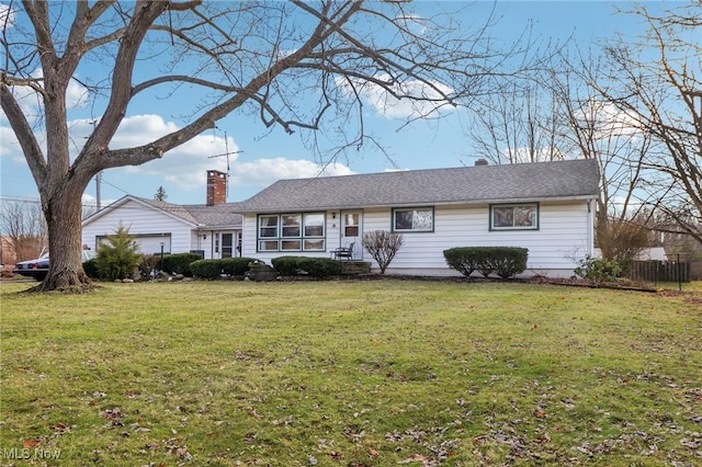 ranch-style house featuring a garage and a front lawn