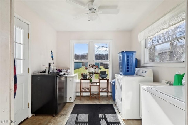 laundry area with separate washer and dryer and ceiling fan