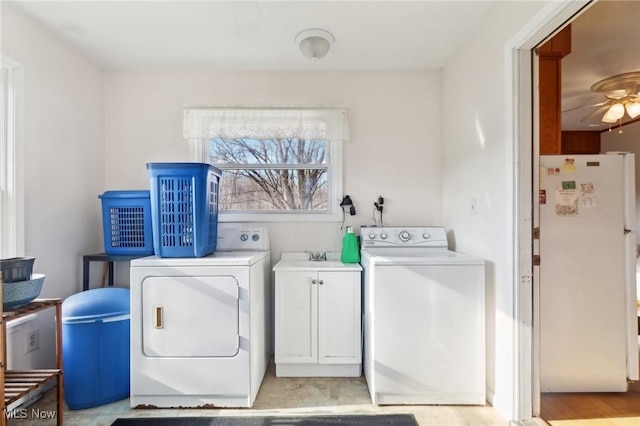 laundry room featuring washer and clothes dryer, ceiling fan, cabinets, and sink