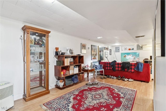 interior space featuring hardwood / wood-style floors and crown molding