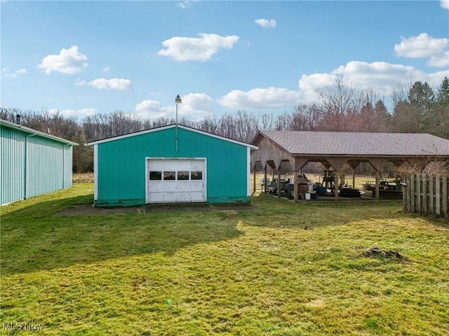 view of outdoor structure featuring a lawn and a garage