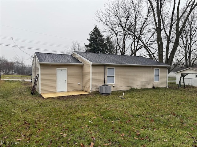 rear view of house with a yard, cooling unit, and a patio area