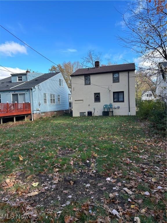 rear view of house featuring a lawn