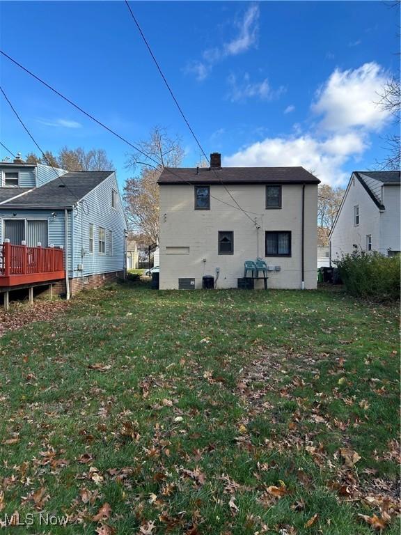 back of house with a lawn