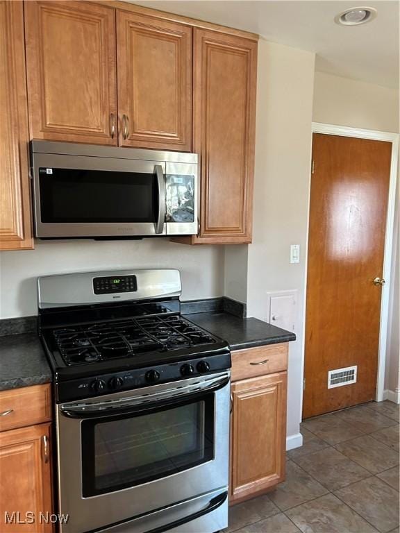 kitchen with stainless steel appliances and tile patterned floors