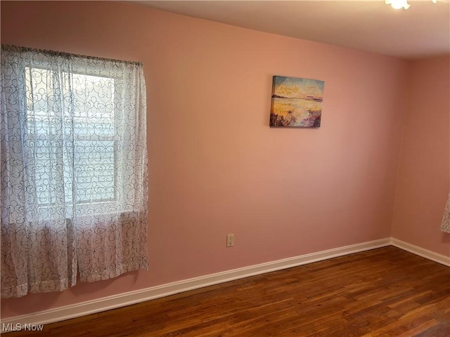 unfurnished room featuring dark hardwood / wood-style floors