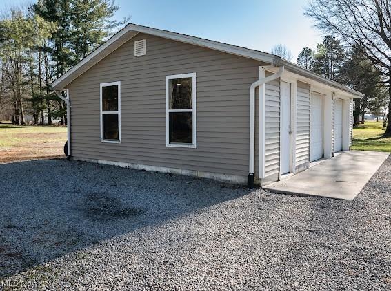 view of side of home featuring a garage