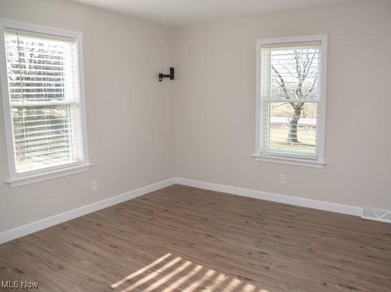 empty room with dark wood-type flooring