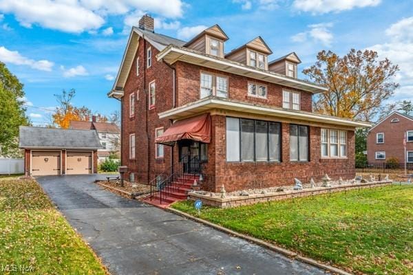 159 Kenilworth Ave SE, Warren, OH 44483 - traditional style home featuring fence, a chimney, a front yard, brick siding, and an outbuilding