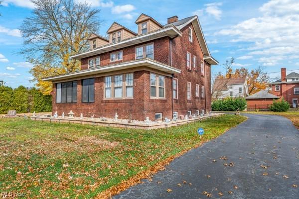159 Kenilworth Ave SE, Warren, OH 44483 - view of home's exterior with brick siding and a lawn