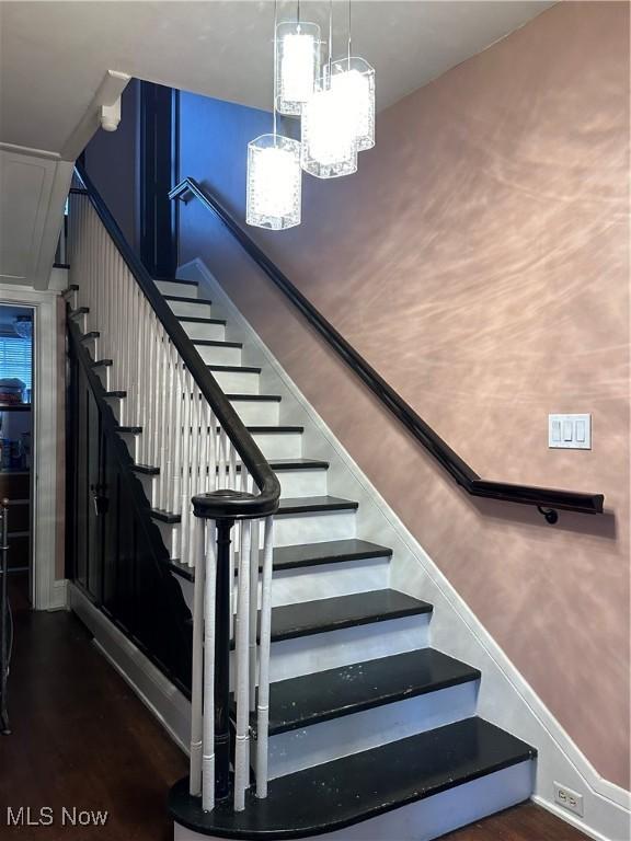 159 Kenilworth Ave SE, Warren, OH 44483 - stairway featuring wood finished floors and a chandelier
