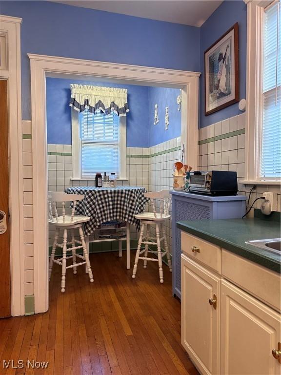 159 Kenilworth Ave SE, Warren, OH 44483 - dining space with hardwood / wood-style flooring, a wainscoted wall, and tile walls