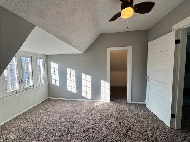 bonus room with vaulted ceiling, ceiling fan, carpet floors, and a textured ceiling